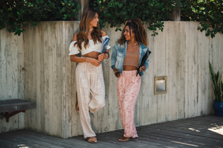 Two students walking to class in harem pants 