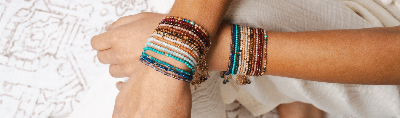 Woman wearing master healer healing bracelet in 4mm and 2mm. Colorful healing energy stone bracelets. Dainty gold chain bracelet.