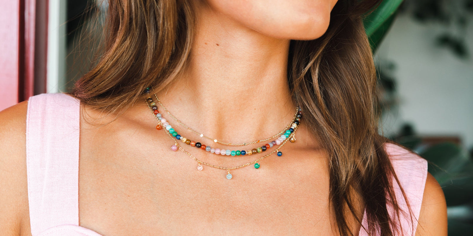 Master Healer Necklace. Stacked with other dainty healing necklaces. Multiple healing stones including jade, rose quartz, moonstone, and Tiger's Eye.