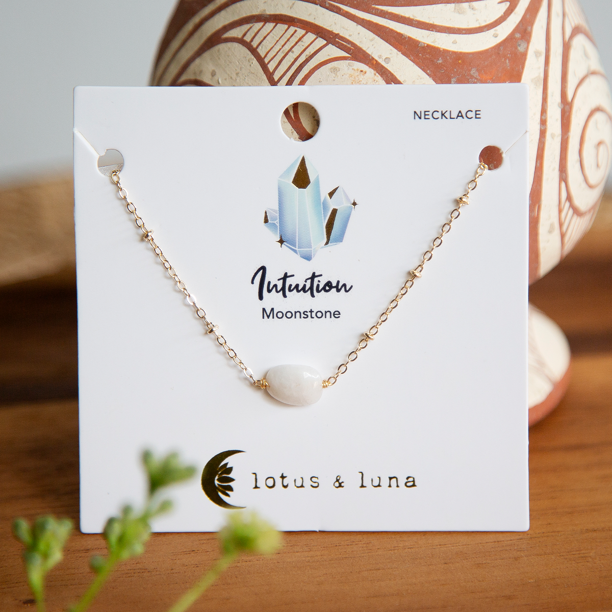 Moonstone healing necklace with gold chain on jewelry card