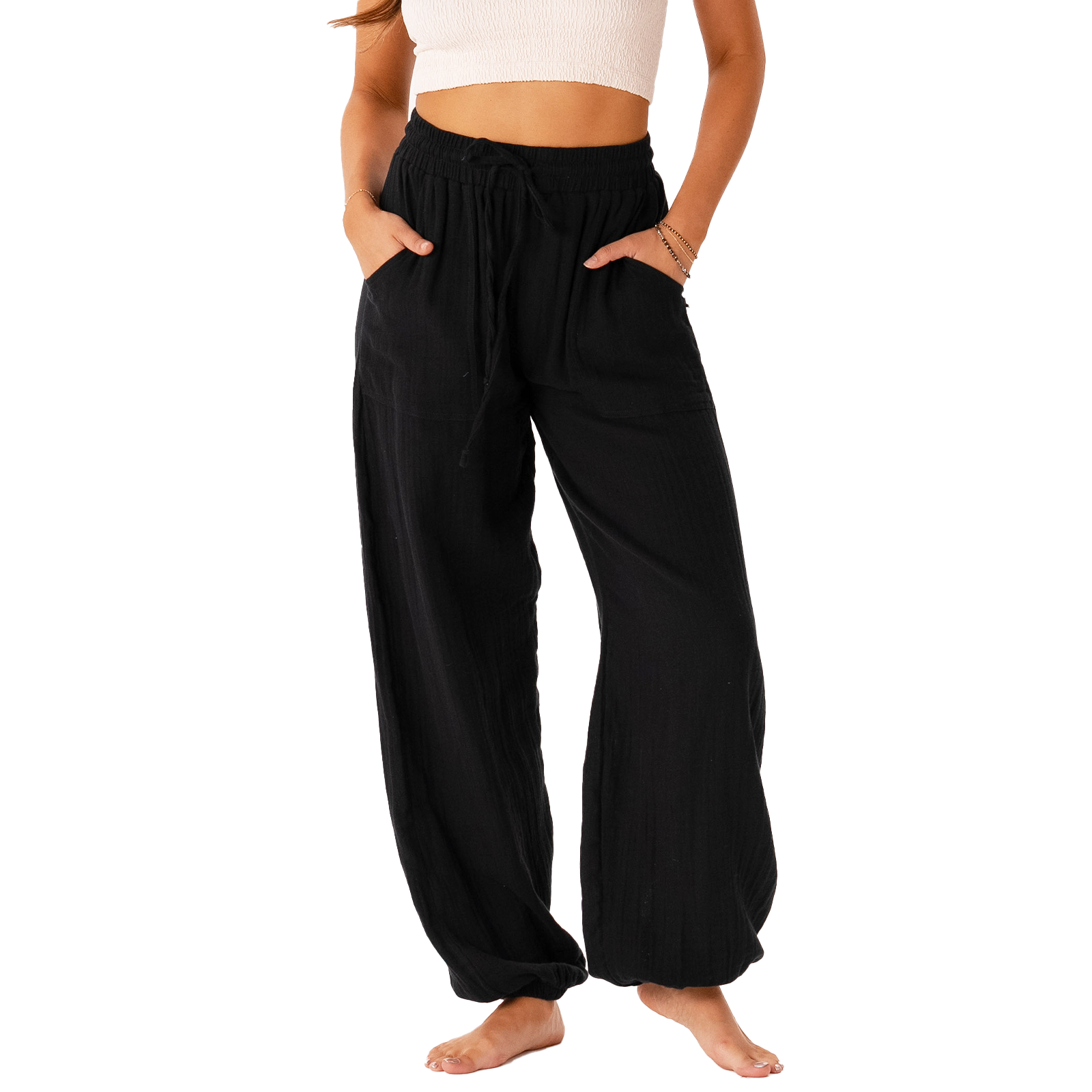 Model wearing black harem pants with a drawstring waistband