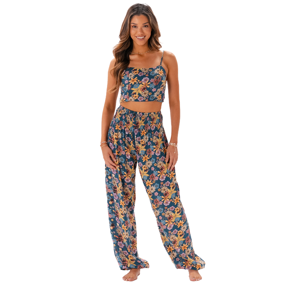 Model wearing blue, pink, orange and yellow floral print harem pants and a matching tank top