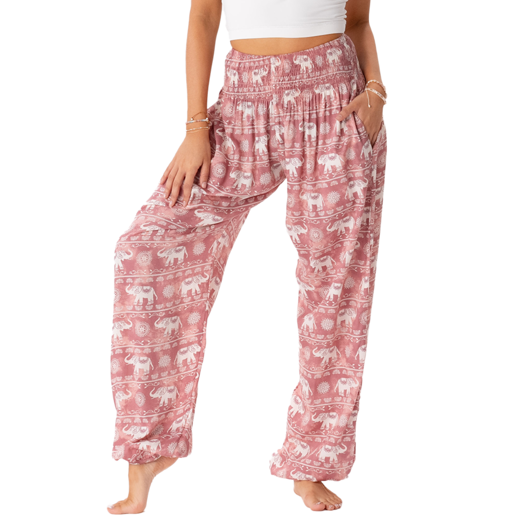 Model wearing pink harem pants with white elephant stripe pattern