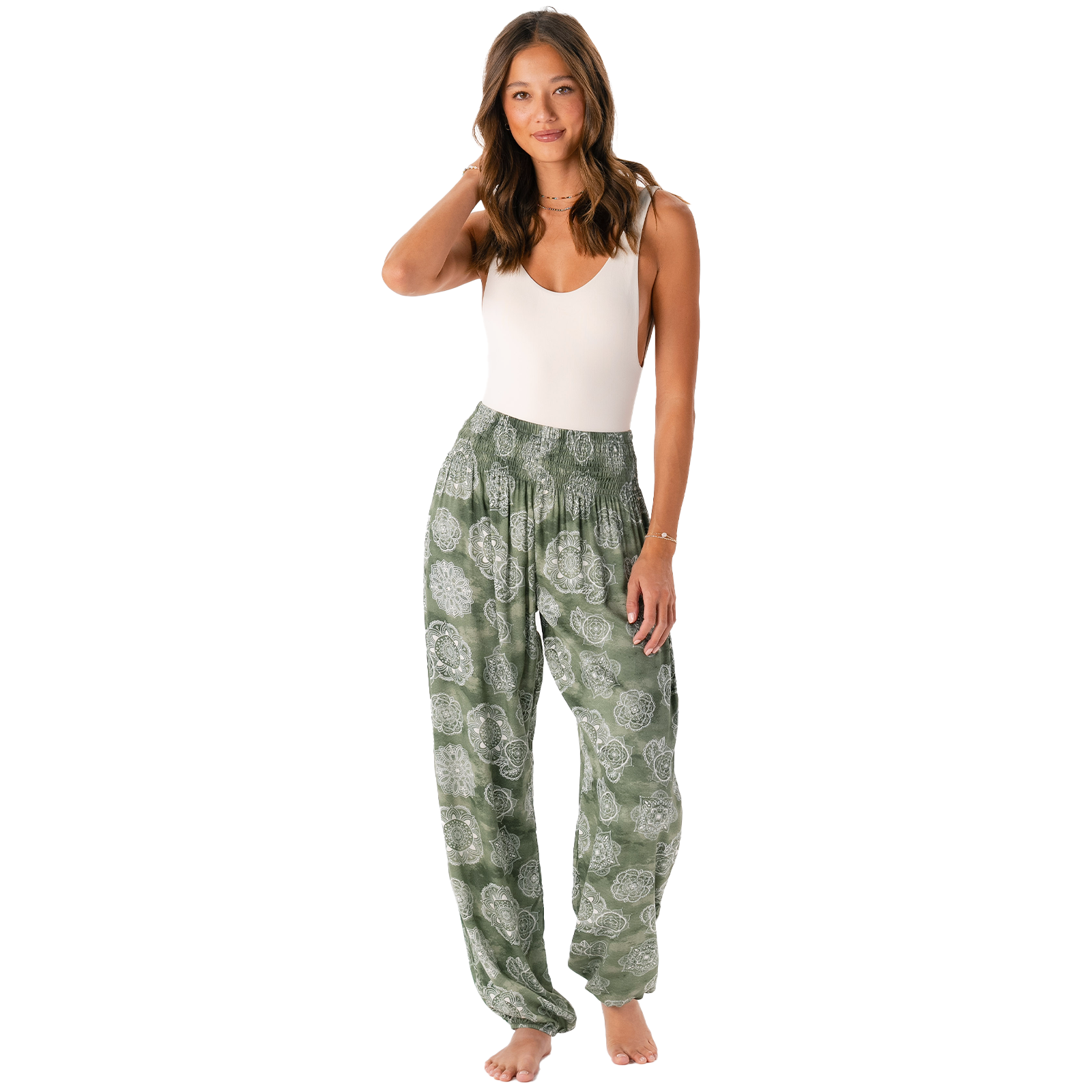 Model wearing olive colored harem pants with a white lace mandala print