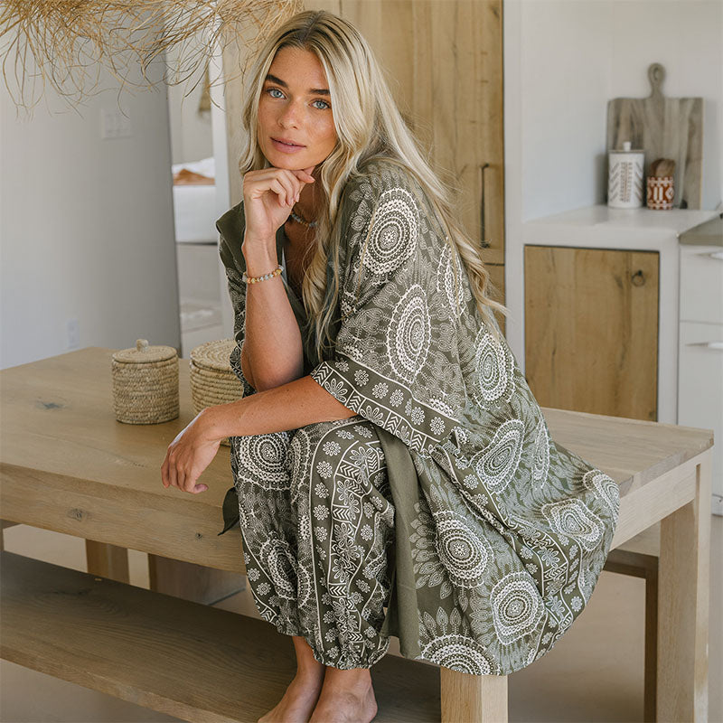 Misprint Tuscany Harem Pants, warmer olive than regular Tuscany, seated on a table with kimono