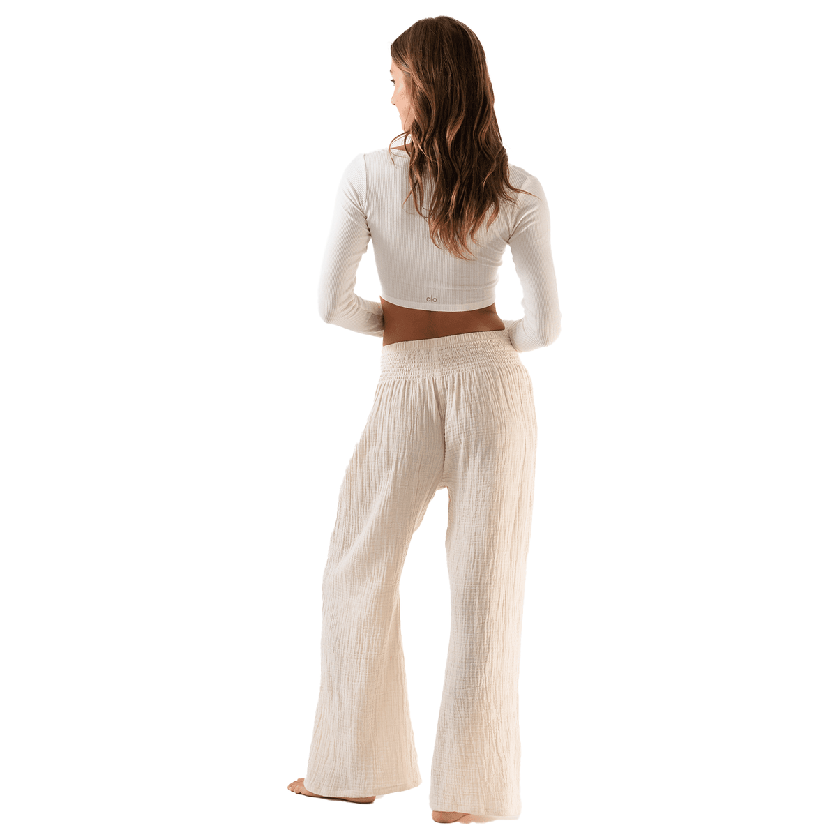 Model wearing cream wide leg cotton gauze pants