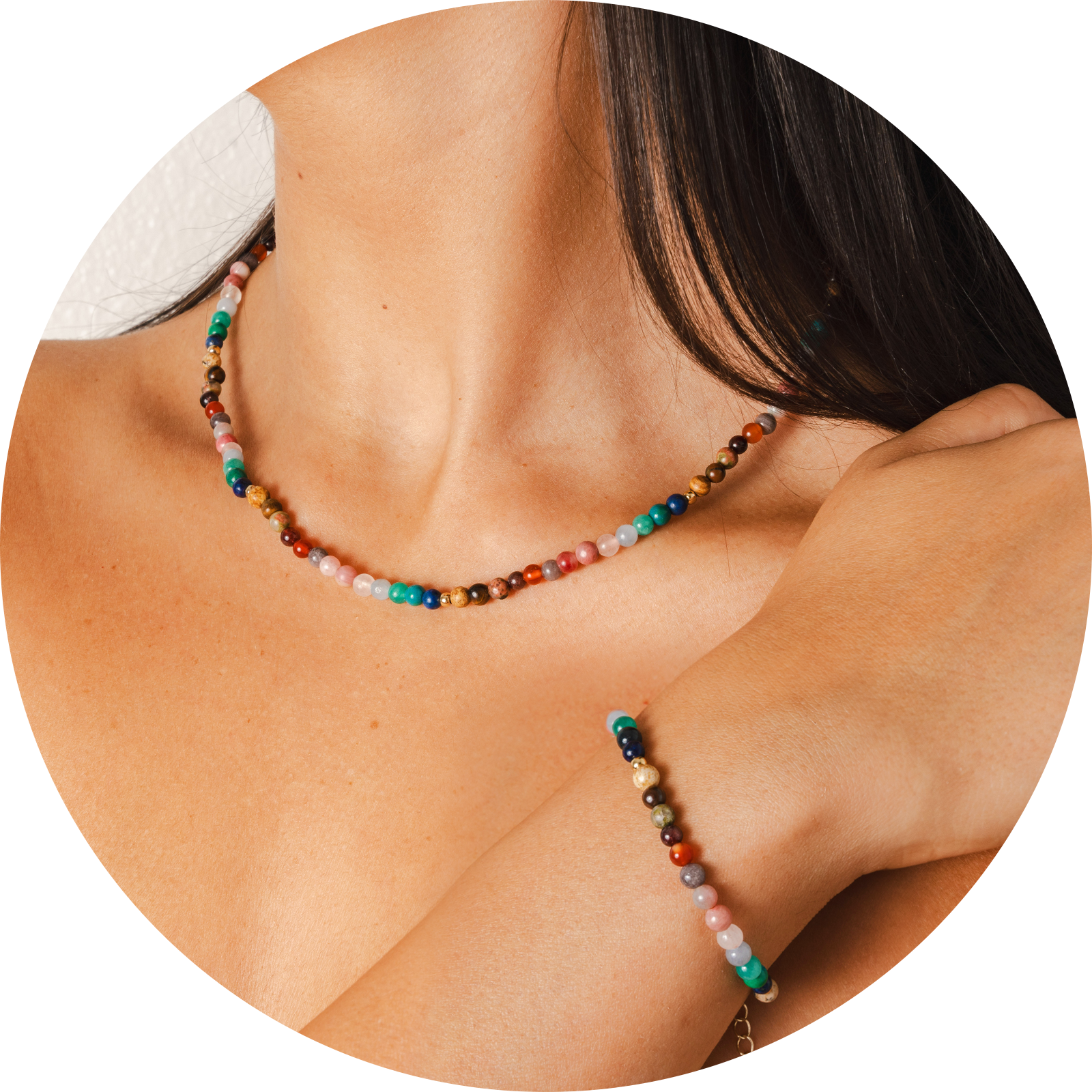 Model wearing a healing necklace and bracelet set. The set includes a 4mm multicolor stone healing bracelet and a 4mm multicolor stone healing necklace.