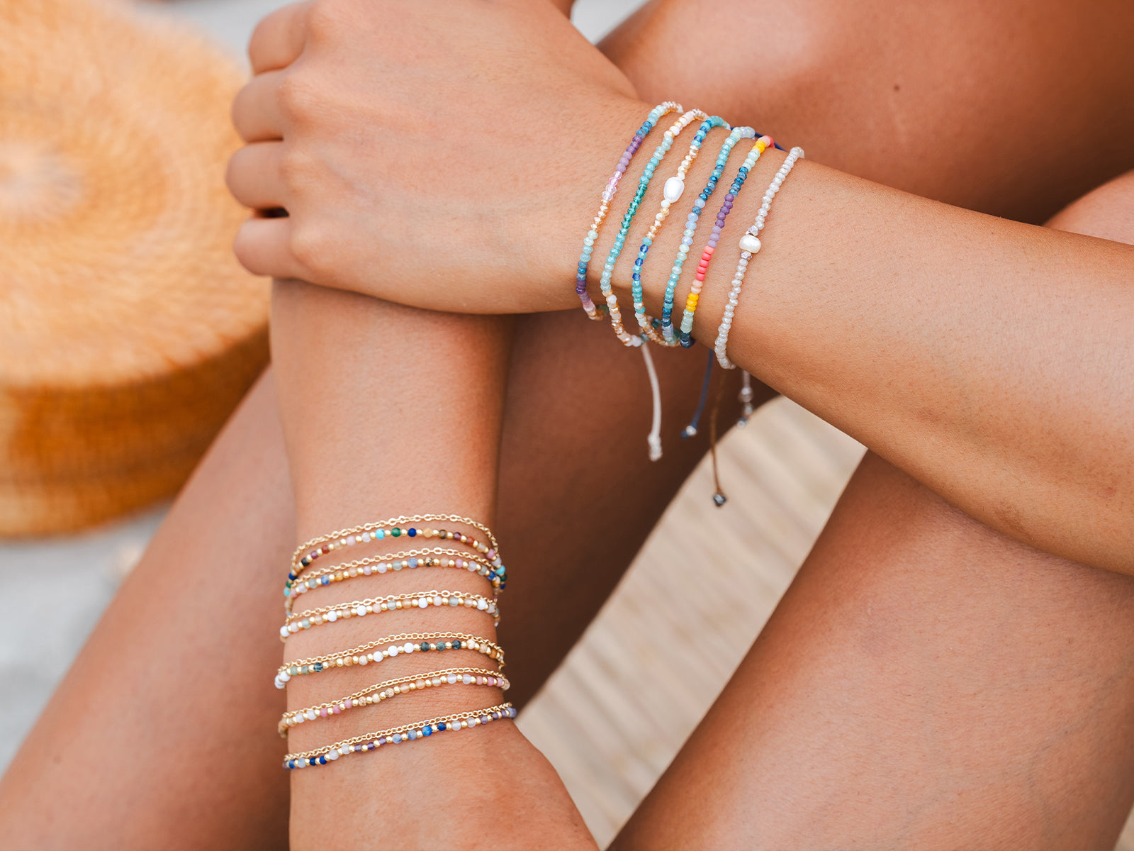 close up of two wrists stacked with 2mm layered bracelet and goddess bracelets