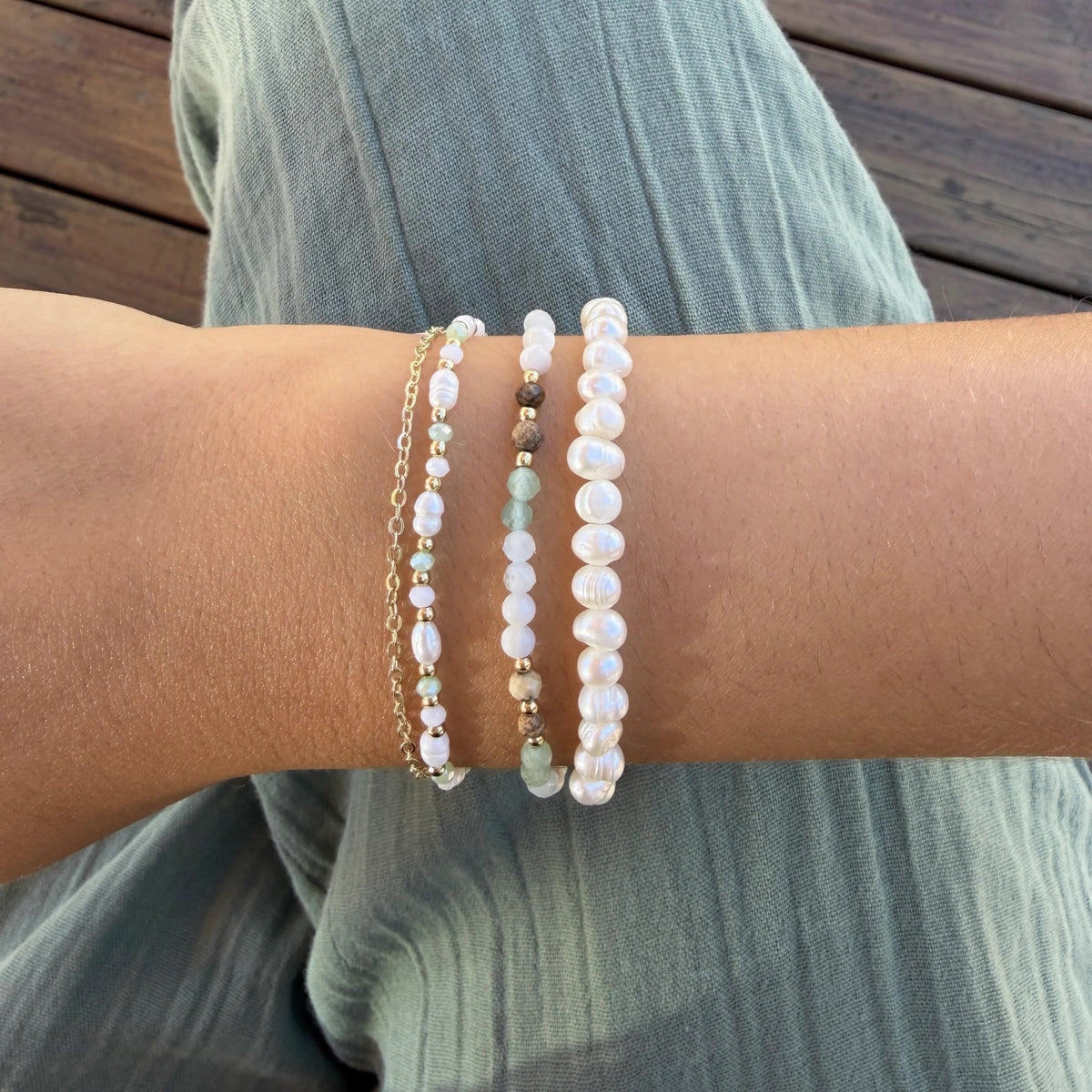 Strength + Inner Peace 3mm Healing Bracelet, stacked on wrist with green pants