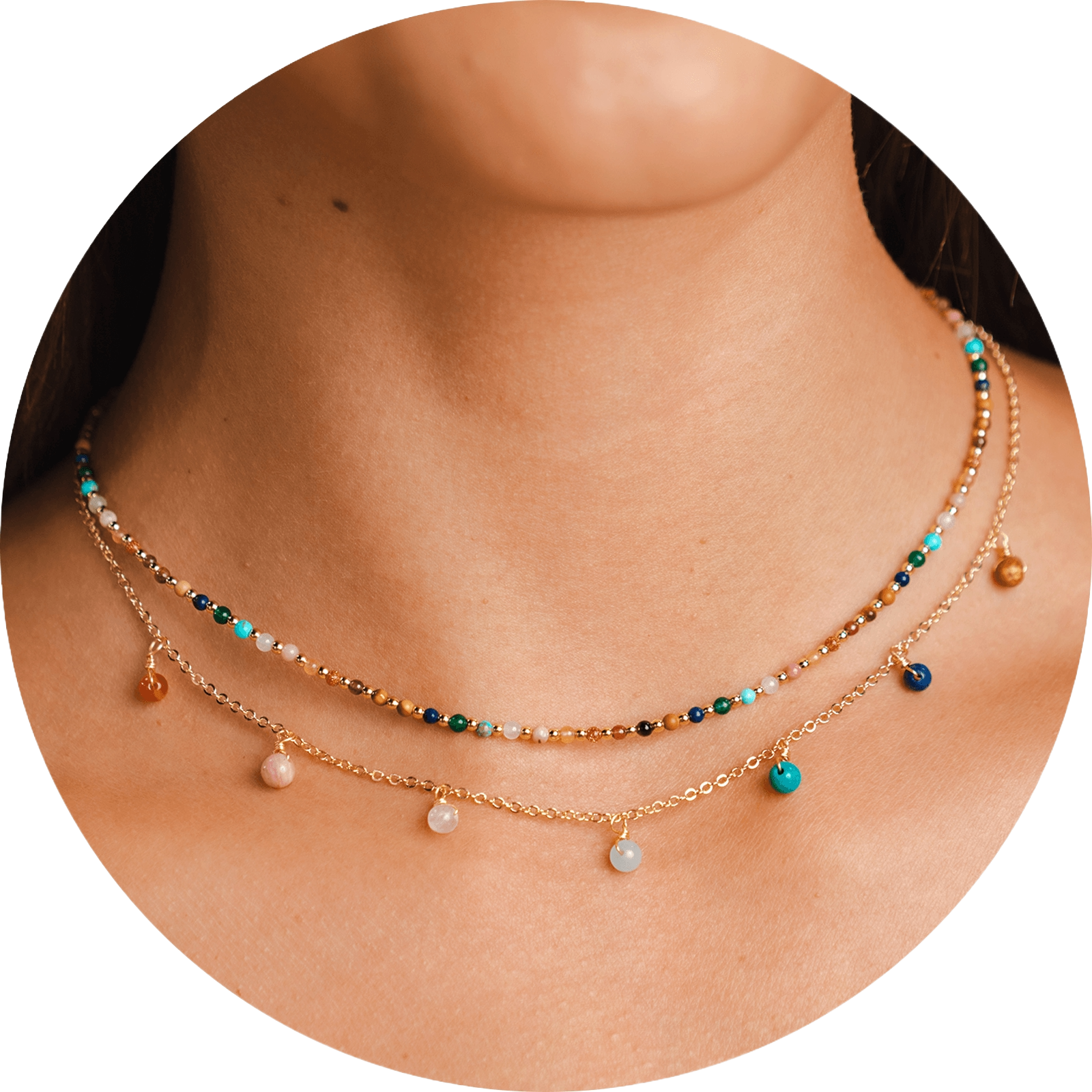 Necklace stack with a gold chain necklace with assortment of rainbow bead dewdrop charms and a 2mm assorted rainbow stone and gold bead necklace