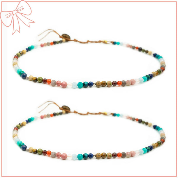 Two matching 6mm multicolor stone healing necklaces with coconut button closures